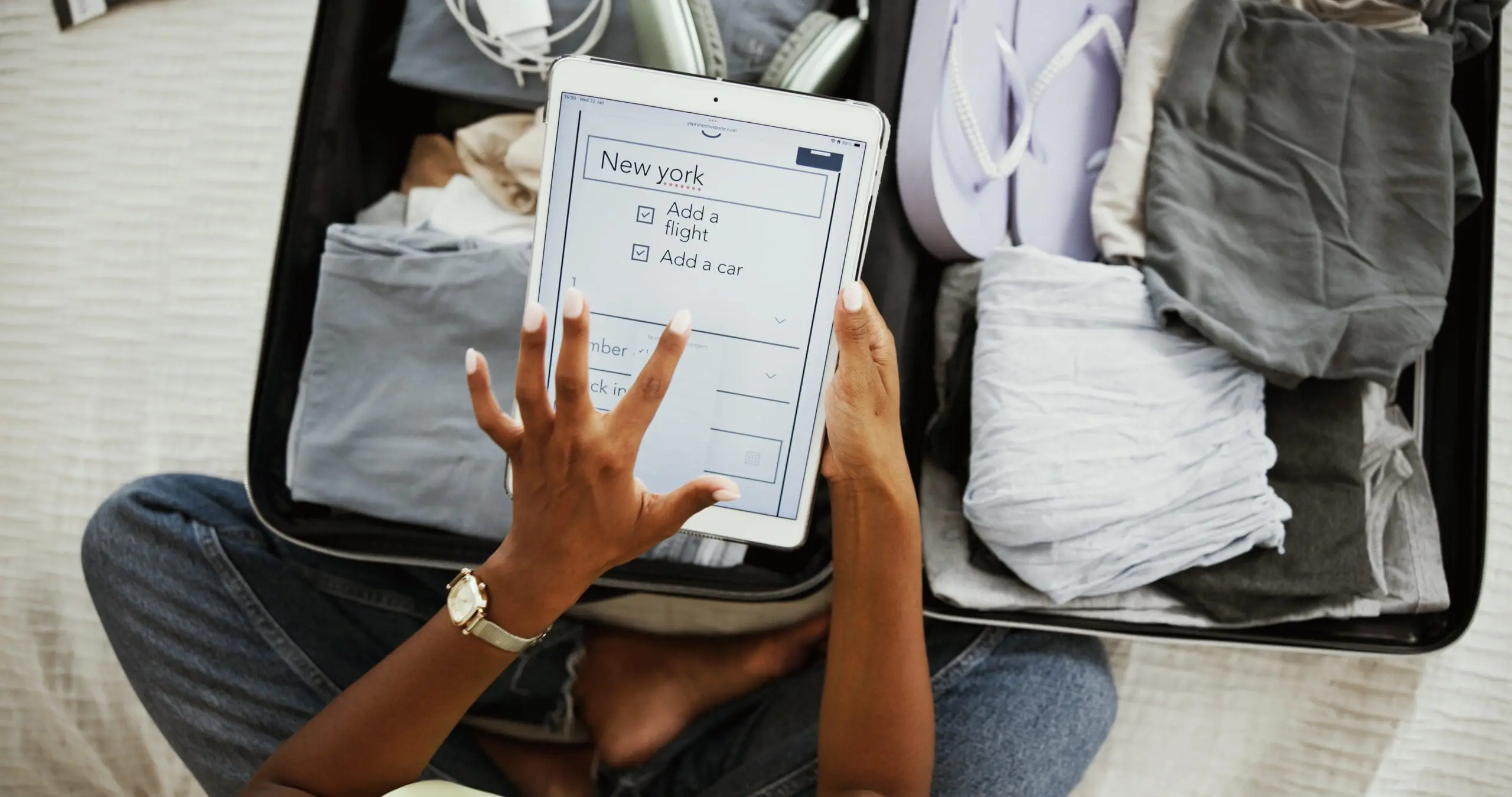 Suitcase, tablet screen and travel with hands of woman at home for app, online booking.