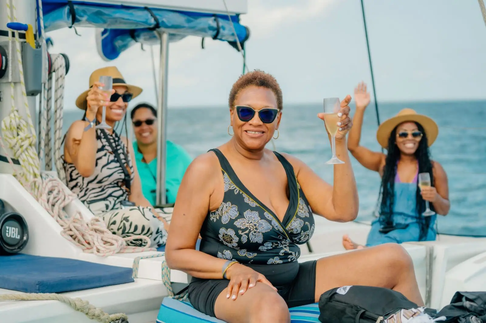 travel divas raising a glass while sailing on a boat in the Indian Ocean off the coast of Zanzibar