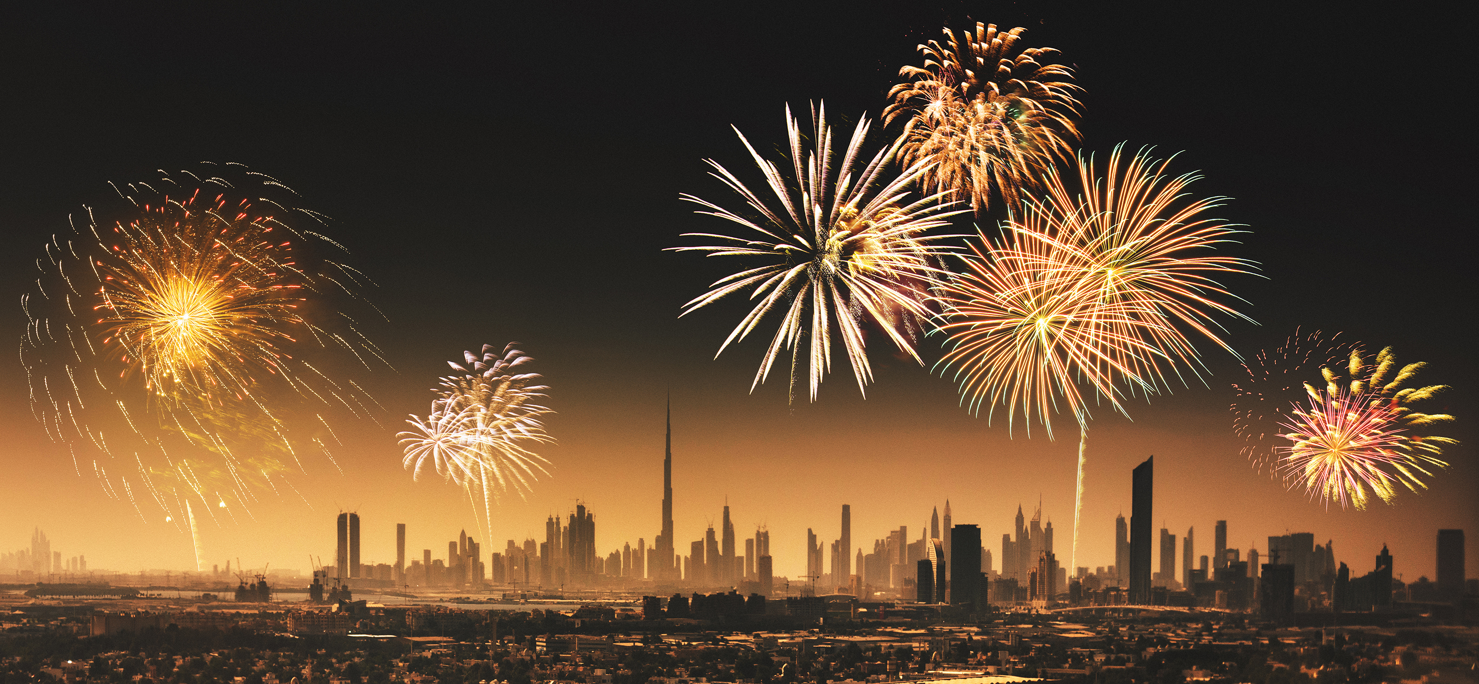 City lights of Dubai downtown with fireworks