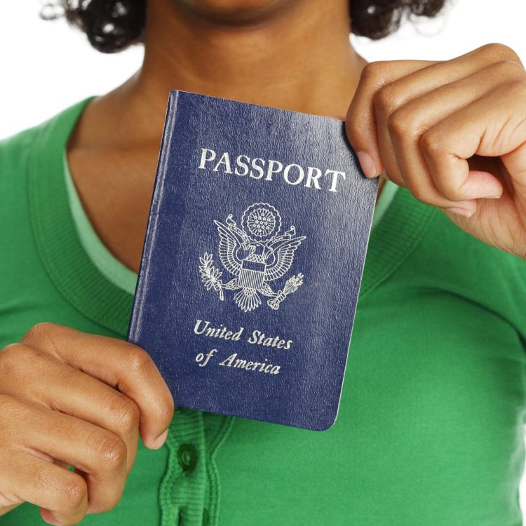 Close-up of a passport being held in a woman's hands.