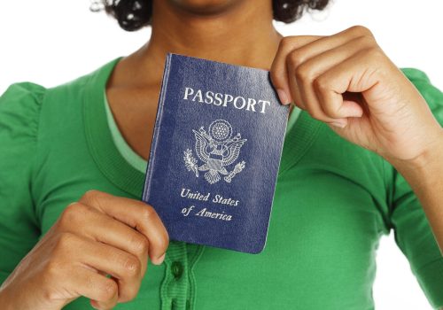 Close-up of a passport being held in a woman's hands.