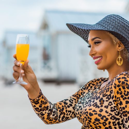 Beautiful mixed race Woman wearing stylish elegant leopard outfit on a beach
